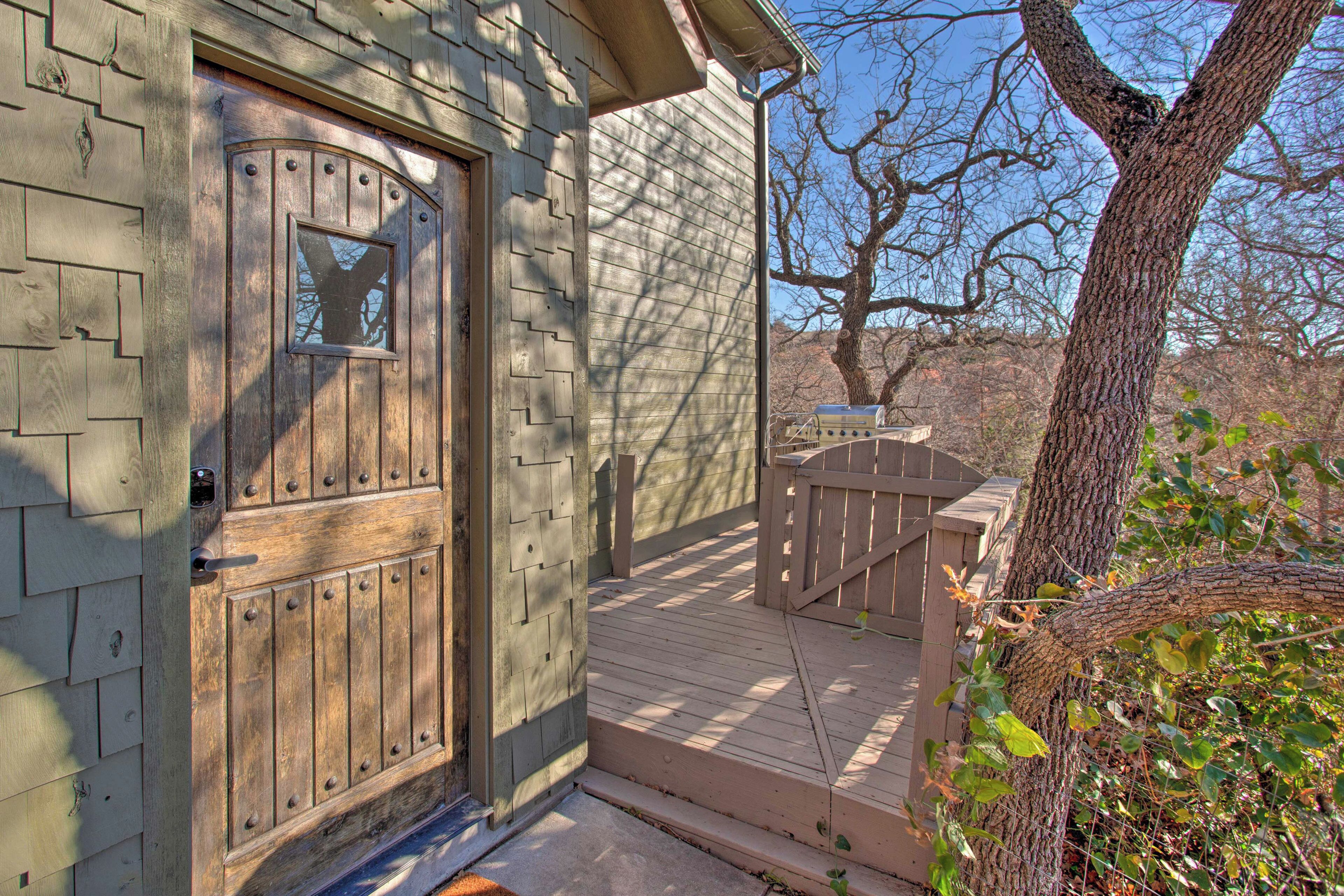 A wooden house with a wooden door and a porch.