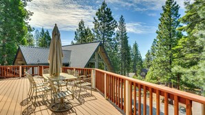 A wooden deck with outdoor furniture and a railing. - Pet-friendly California Cabin w/ Beach Access (Chester)