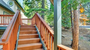A wooden staircase with a railing leading to a covered area. - Pet-friendly California Cabin w/ Beach Access (Chester)
