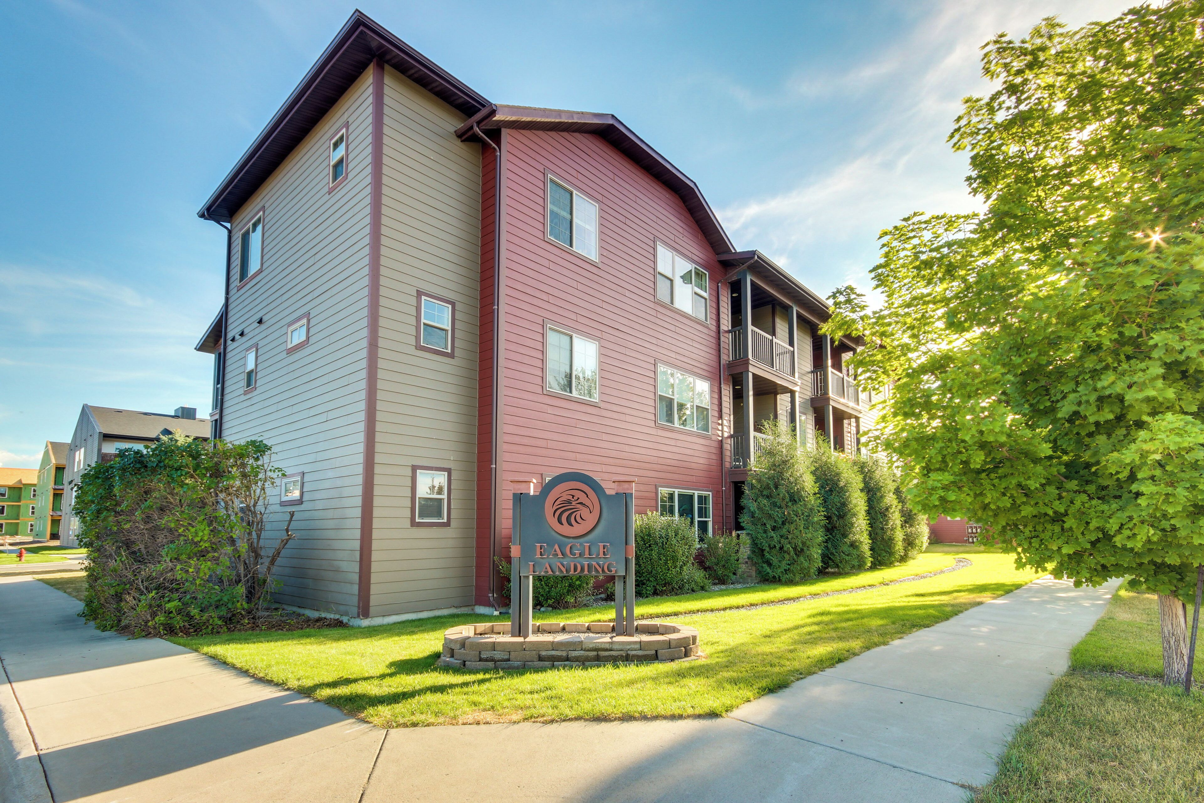 A multi-story residential building with a sign reading "Eagle Landing."