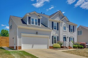 A two-story house with a garage, a front porch, and a well-maintained lawn. - Graham Home w/ Private Pool & Ping-pong Table! (Graham)