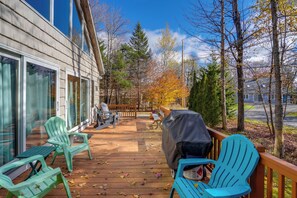 A wooden deck with outdoor seating, a barbecue grill, and a view of a forested area. - 'luna Stella' - West Dover Home 1 Mi to Mt Snow! (West Dover)
