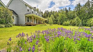 A two-story house with a covered porch and a well-maintained lawn. - Wilmington Home on 18 Acres ~ 9 Mi to Skiing! (Wilmington)