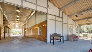 A spacious indoor area with a high ceiling, wooden panel walls, and a long corridor leading to a door. - Georgetown Barn Studio on > 7 Acres: Pet Friendly! (Georgetown)