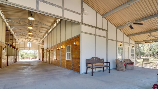 A spacious indoor area with a high ceiling, wooden panel walls, and a long corridor leading to a door. - Georgetown Barn Studio on > 7 Acres: Pet Friendly! (Georgetown)