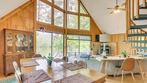 A spacious dining area with a wooden table, chairs, and a view of the outdoors. - Riverfront Shelby Home w/ Private Boat Dock! (Shelby)