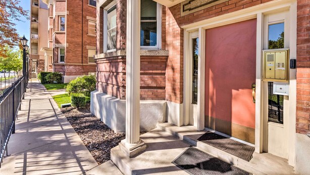 A building entrance with a red door, a mailbox, and a mailbox slot. - Salt Lake City Condo < 28 Mi to Ski Resort! (Salt Lake City)
