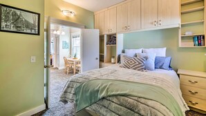 A bedroom with a bed, a desk, and a chair. There is a door leading to another room. - Salt Lake City Condo < 28 Mi to Ski Resort! (Salt Lake City)