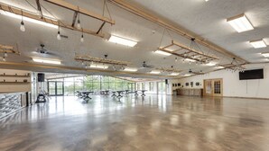 A spacious room with a polished concrete floor, wooden beams, and multiple light fixtures. - Cozy Cassopolis Cabin, Near Parks & Golfing! (Cassopolis)