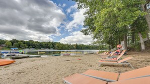 A beach with lounge chairs and boats. - Cozy Cassopolis Cabin, Near Parks & Golfing! (Cassopolis)