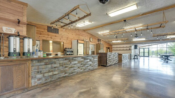 A spacious kitchen with a stone countertop, wooden cabinets, and modern appliances. - Cozy Cassopolis Cabin, Near Parks & Golfing! (Cassopolis)