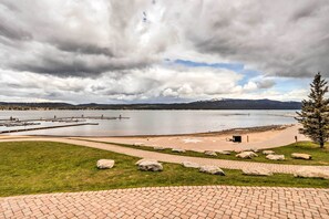 A lakeside park with a paved walkway, large rocks, and a dock extending into the water. - Central Mccall Getaway: Walk to Payette Lake! (McCall)