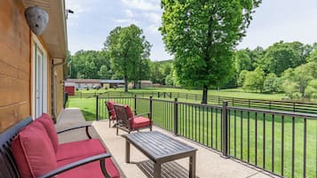 Enjoy the serene view of lush green surroundings from this balcony.