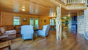 A spacious wooden cabin interior with a living area, dining space, and a kitchen. - Cabin Near Grand Lake' w/ Private Deck! (Fairland)