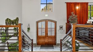 A staircase leading to a wooden door with a small window above it. - Watson @ The Vestry on Read (Columbia)