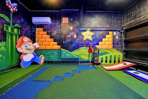 A Mario-themed play area with a brick wall, air conditioning unit, and a star decoration.