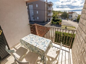 Enjoy a romantic meal for two on this balcony with a table set amidst a nautical theme.