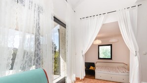 A room with a large window, a bed, a sofa, and a chair. - Apartments Ilija Njavro - Studio Apartment (Jadranovo)