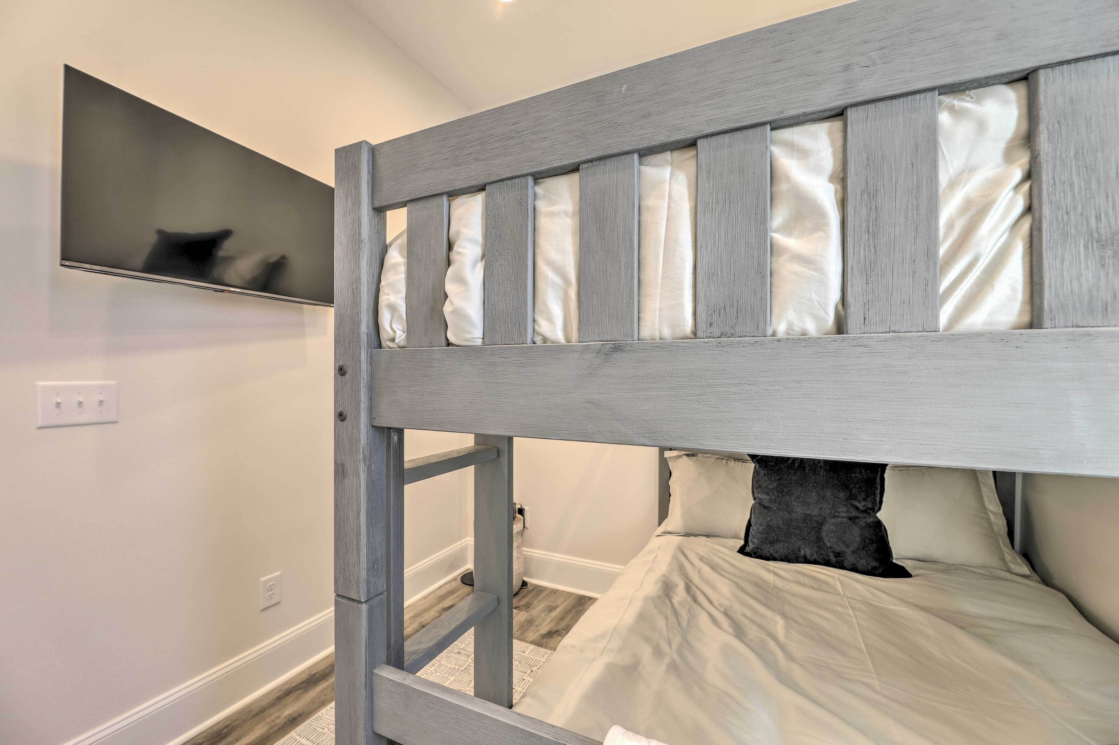 A bunk bed with a headboard, a mirror, and a pillow.