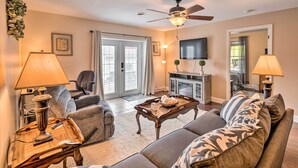 A living room with a sofa, armchairs, a coffee table, a TV, and a ceiling fan. - Bristol Escape w/ Patio, 2 Mi to Downtown! (Bristol)
