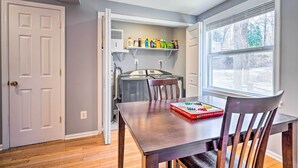 A dining area with a table, chairs, and a window.