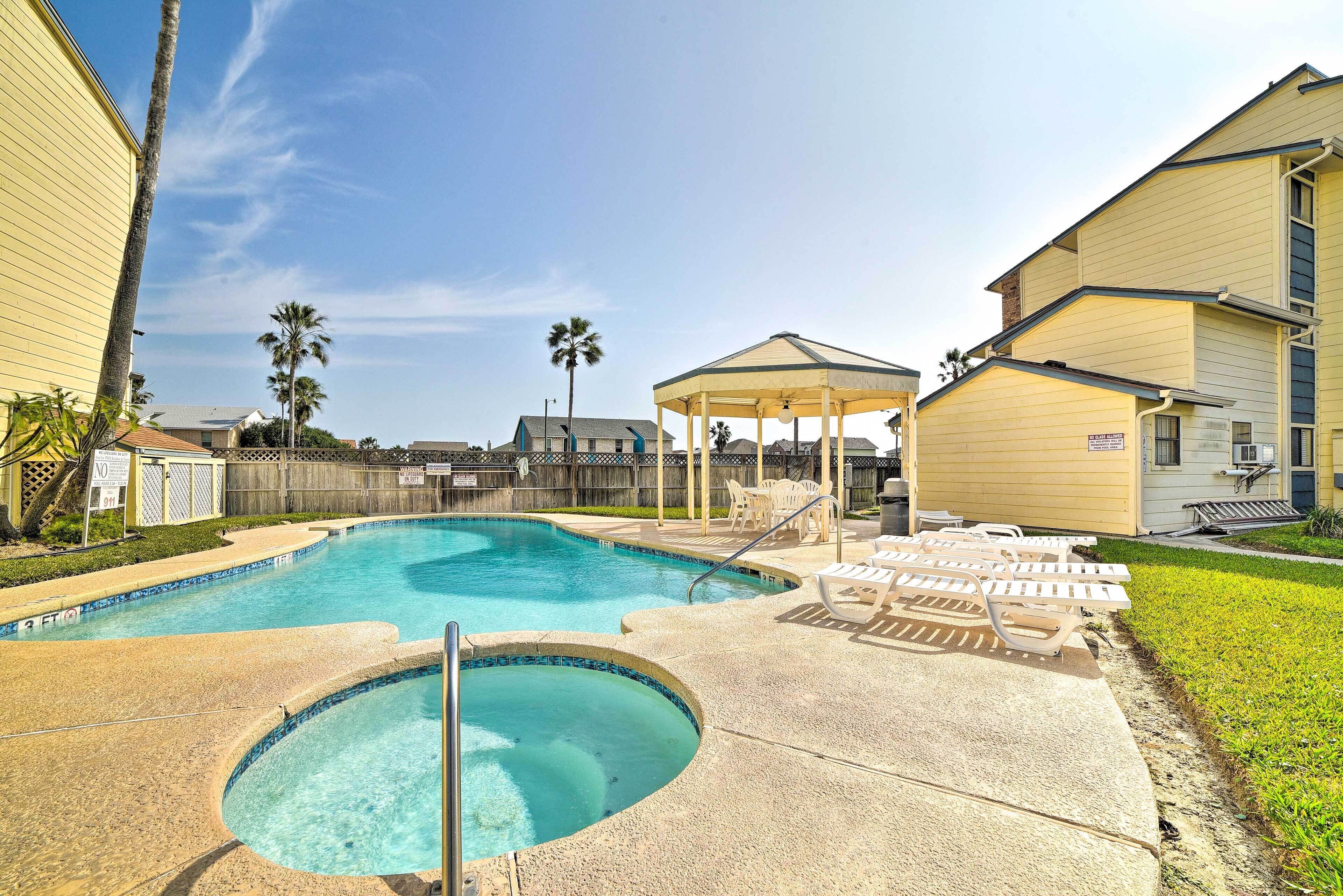A swimming pool with lounge chairs and a gazebo.