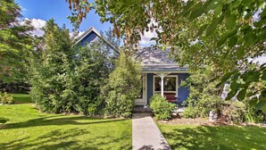 A house with a front porch, surrounded by well-maintained lawns and trees. - Cozy Home w/ Hot Tub: Half Mi to Salmon River! (Salmon)