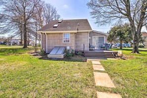 A single-story house with a front porch, a small deck, and a visible garage door.
