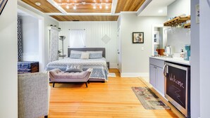 A bedroom with a bed, bedside table, and a dresser with a 'Welcome' sign. - Historic Bemus Point Studio w/ Porch: Walk to Lake (Bemus Point)