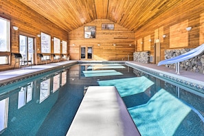 A large indoor swimming pool with wooden walls and a high ceiling. - Lodge w/ Indoor Pool, Along Devil's Lake Park (Merrimac)