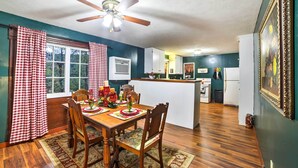 A dining area with a wooden table, chairs, and a ceiling fan. - Historic Bruno 'hampton Creek Hideaway' on 2 Acres (Everton)
