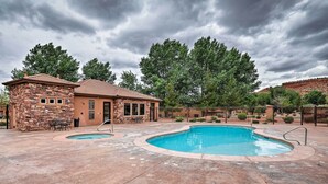 A pool area with a stone building, a small pool, and a fenced garden. - Kanab Condo w/ Pool & Patio, 30 Mi to Zion NP (Kanab)