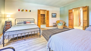 A bedroom with two beds, a wooden wardrobe, a small table, and a chair. - 'lochview Lodge' Idyllic Farmhouse in Grove! (Grove)