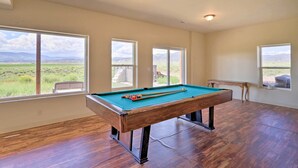 A pool table in a room with large windows offering a view of a grassy field and mountains. - Mtn Gem w/ Breathtaking Scenery: 7 Mi to Dtwn (Del Norte)