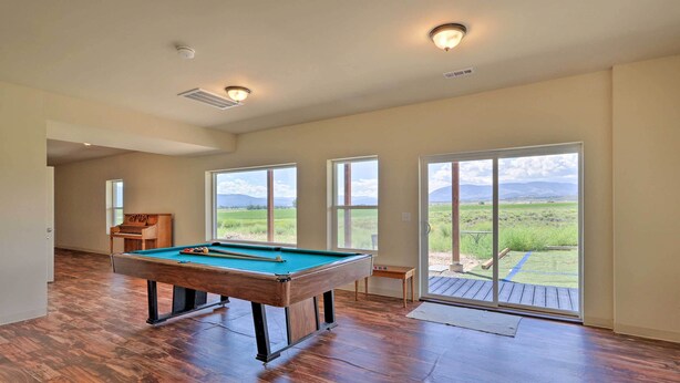 A spacious room with a pool table, large windows, and a view of a green landscape. - Mtn Gem w/ Breathtaking Scenery: 7 Mi to Dtwn (Del Norte)