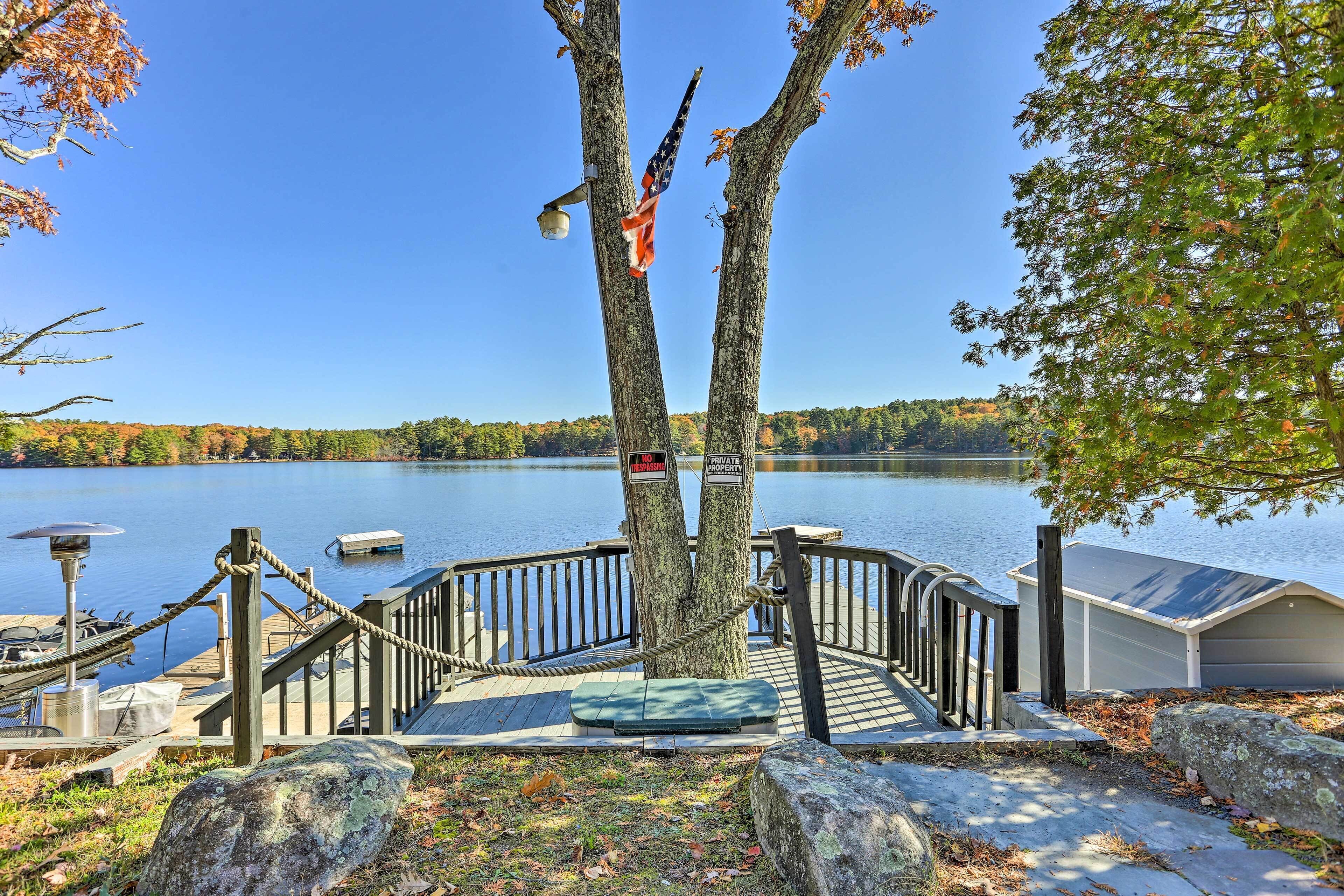 A dock with a rope barrier, a bench, and a solar-powered lamp.