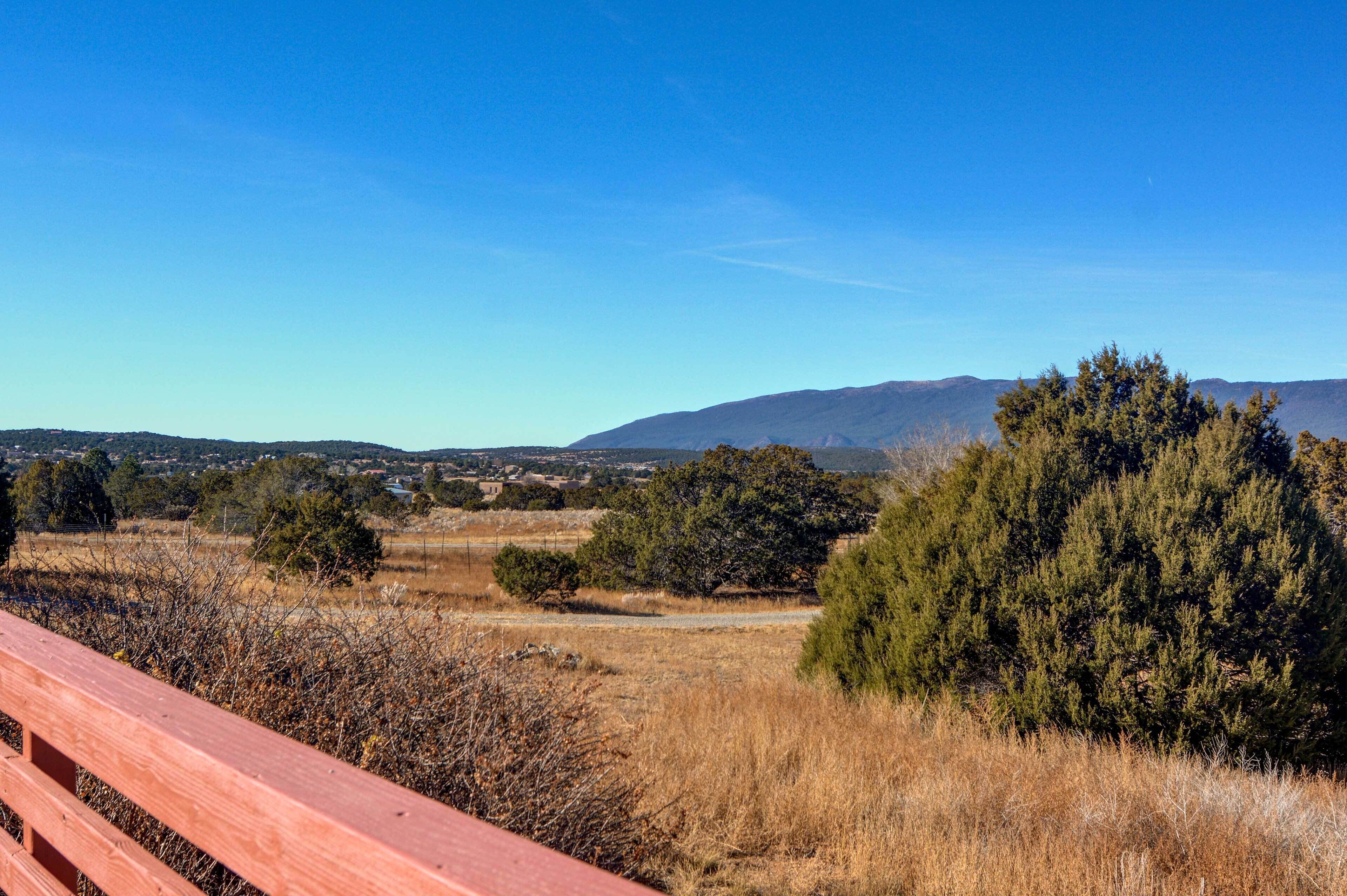 A scenic view of a mountainous landscape with a clear blue sky.