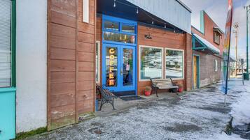 A coffee shop with a blue door and a sign that reads "COFFEE".