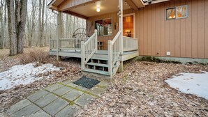 A cabin with a porch, steps, and a small window. - Secluded Farwell Cabin w/ Fire Pit & Gas Grill! (Farwell)