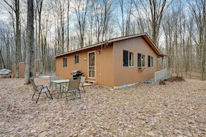 A cabin with a dining area and a small porch.