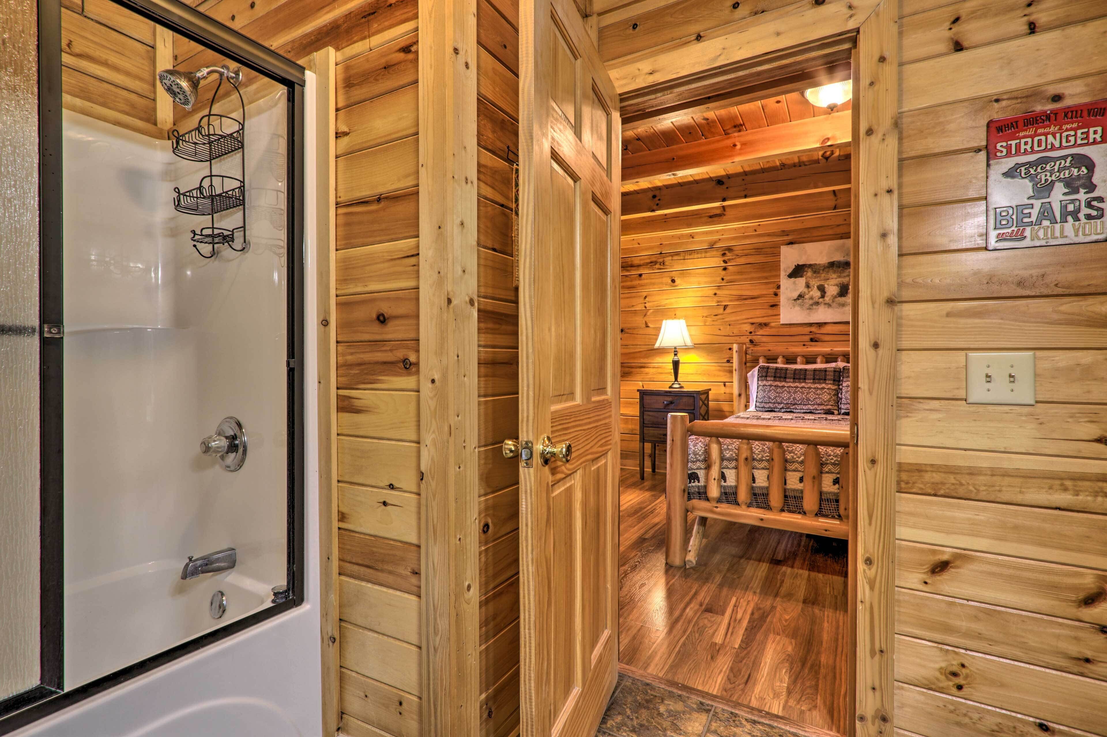 A wooden cabin interior with a shower, a bench, and a sign on the wall.