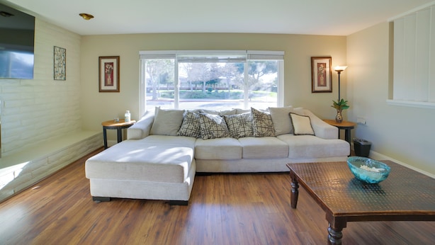 A living room with a sectional sofa, a wooden coffee table, and a large window with blinds. - Quiet Salinas Vacation Rental 10 Mi to Beach (Salinas)