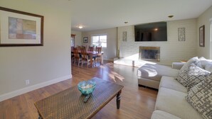 A spacious living room with a dining area, a fireplace, and a large window. - Quiet Salinas Vacation Rental 10 Mi to Beach (Salinas)