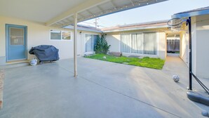 A covered patio area with a concrete floor, a basketball hoop, and a small grassy patch. - Quiet Salinas Vacation Rental 10 Mi to Beach (Salinas)