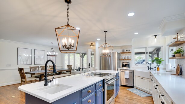 A spacious kitchen with a large island, modern appliances, and pendant lighting. - Spacious Waterfront Hyco Lake Retreat w/ Dock! (Leasburg)