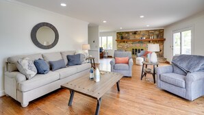 A spacious living room with a sofa, armchairs, and a coffee table. - Spacious Waterfront Hyco Lake Retreat w/ Dock! (Leasburg)