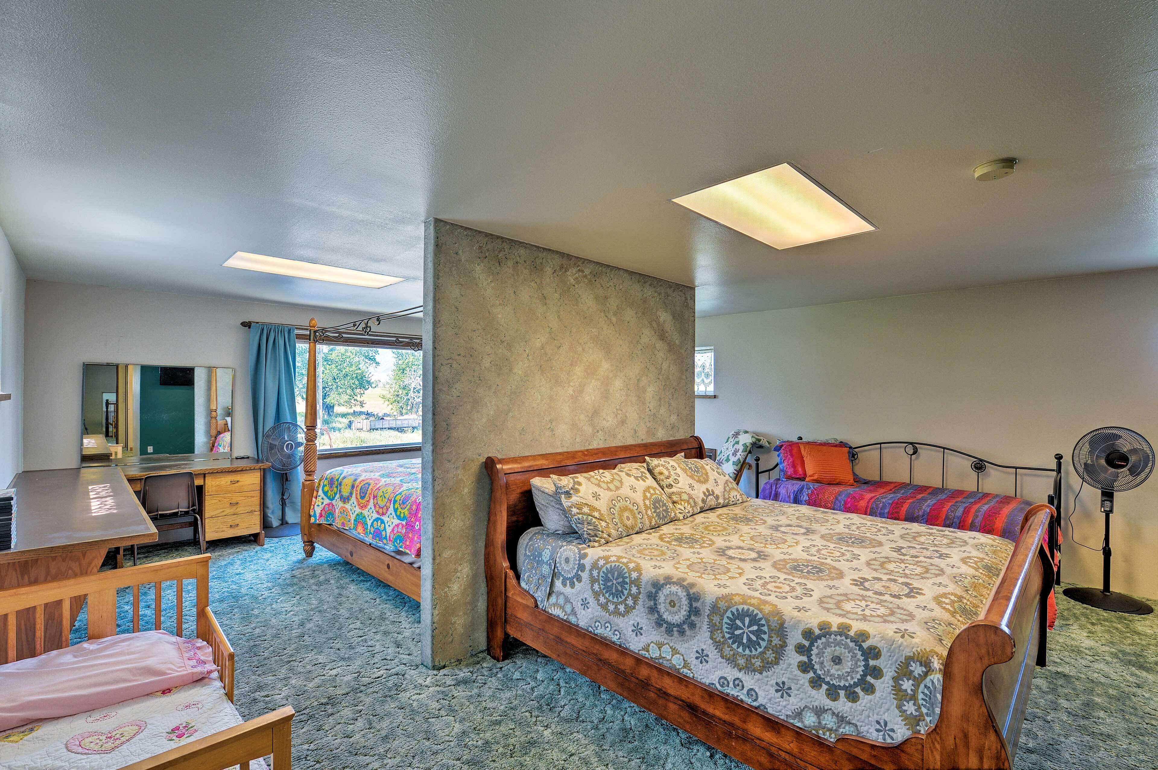A bedroom with a wooden bed, a desk, and a chair.