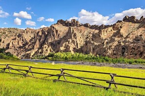 A rugged mountain landscape with a wooden fence in the foreground. - Kayaks & Views: Yellowstone River Lodge in Clark (Powell)