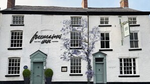 A white building with a sign reading "The Inn." - The Silk Rooms at Freemasons Inn (Knutsford)