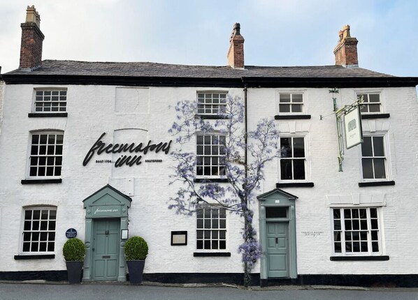 A white building with a sign reading "The Inn." - The Silk Rooms at Freemasons Inn (Knutsford)